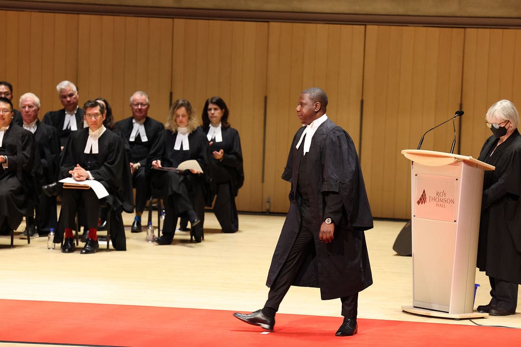 Oluwaseun Quadri crossing the stage at the Ontario call to the bar ceremony, Roy Thomson Hall, Toronto